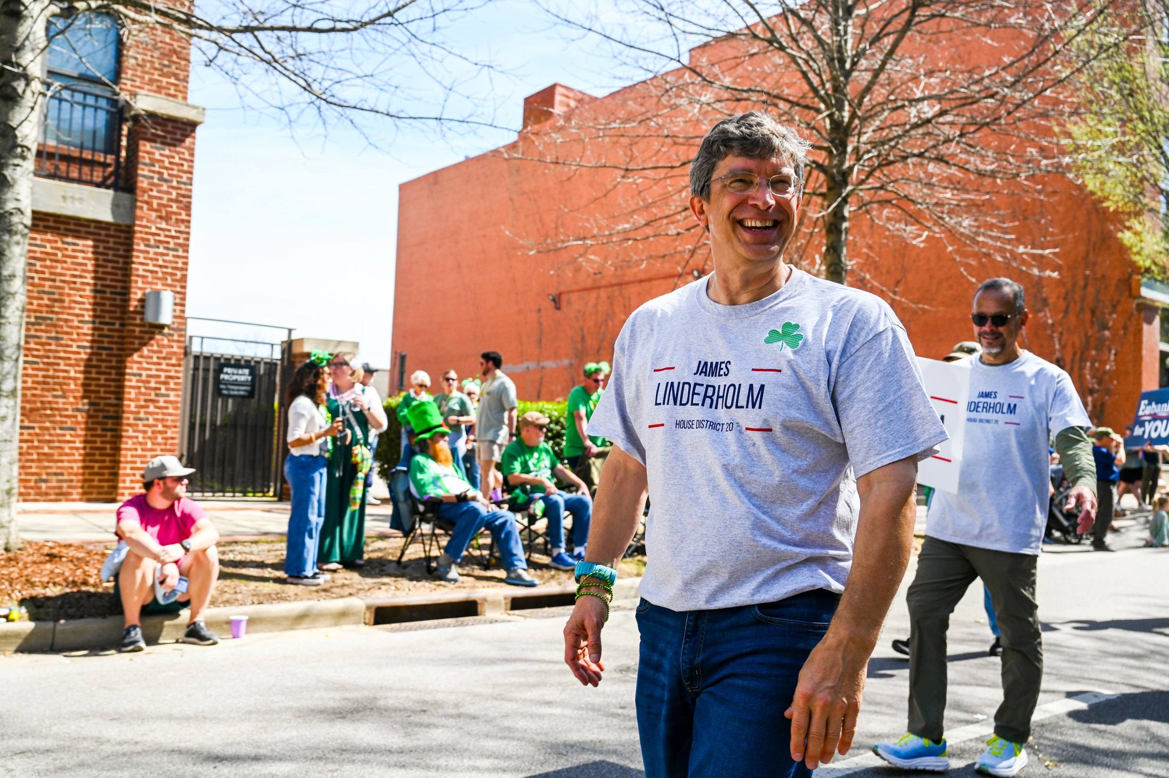 James Linderholm greeting the crowd along a downtown Huntsville street during the parade
