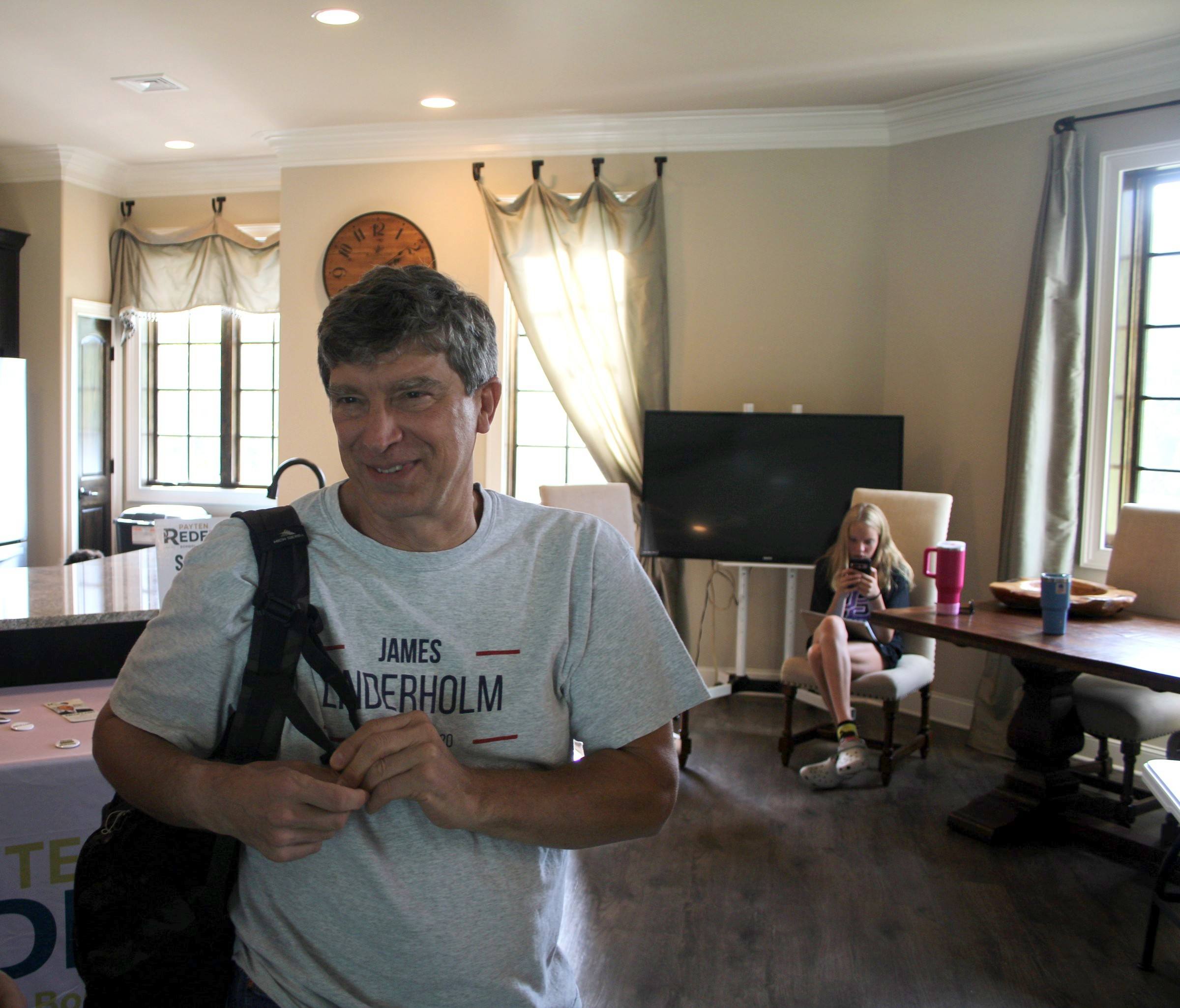 James Linderholm smiling as he talks with supporters at a campaign event in a Huntsville home